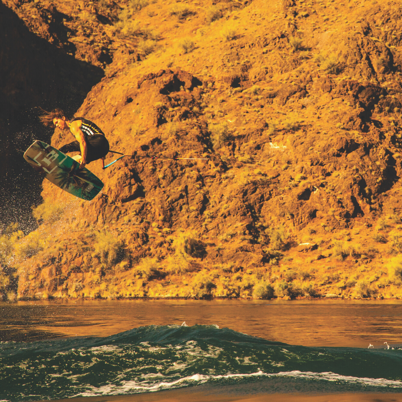Aaron Rathy wakeboarding doing a big air grab